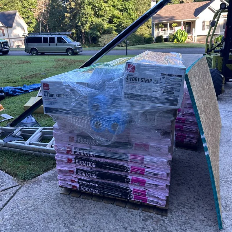 Owens Corning Duration shingles, roof decking and wrapped roofing accessories at a residential jobsite.