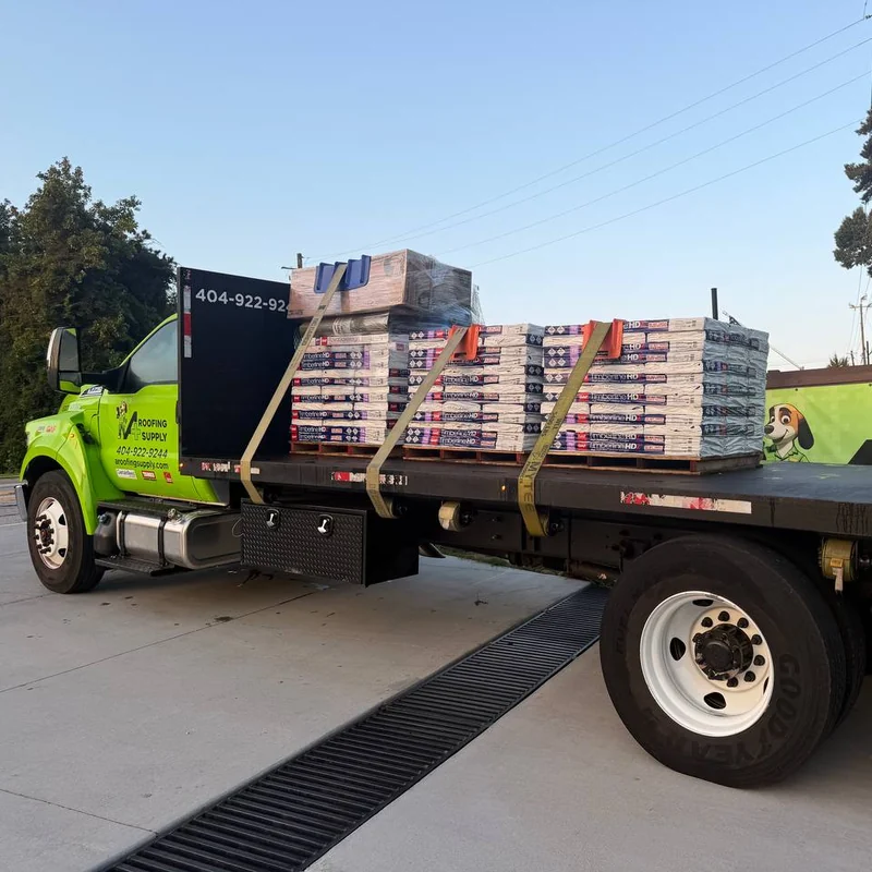 A+ Roofing Supply flatbed truck loaded with GAF Timberline HDZ shingle pallets.
