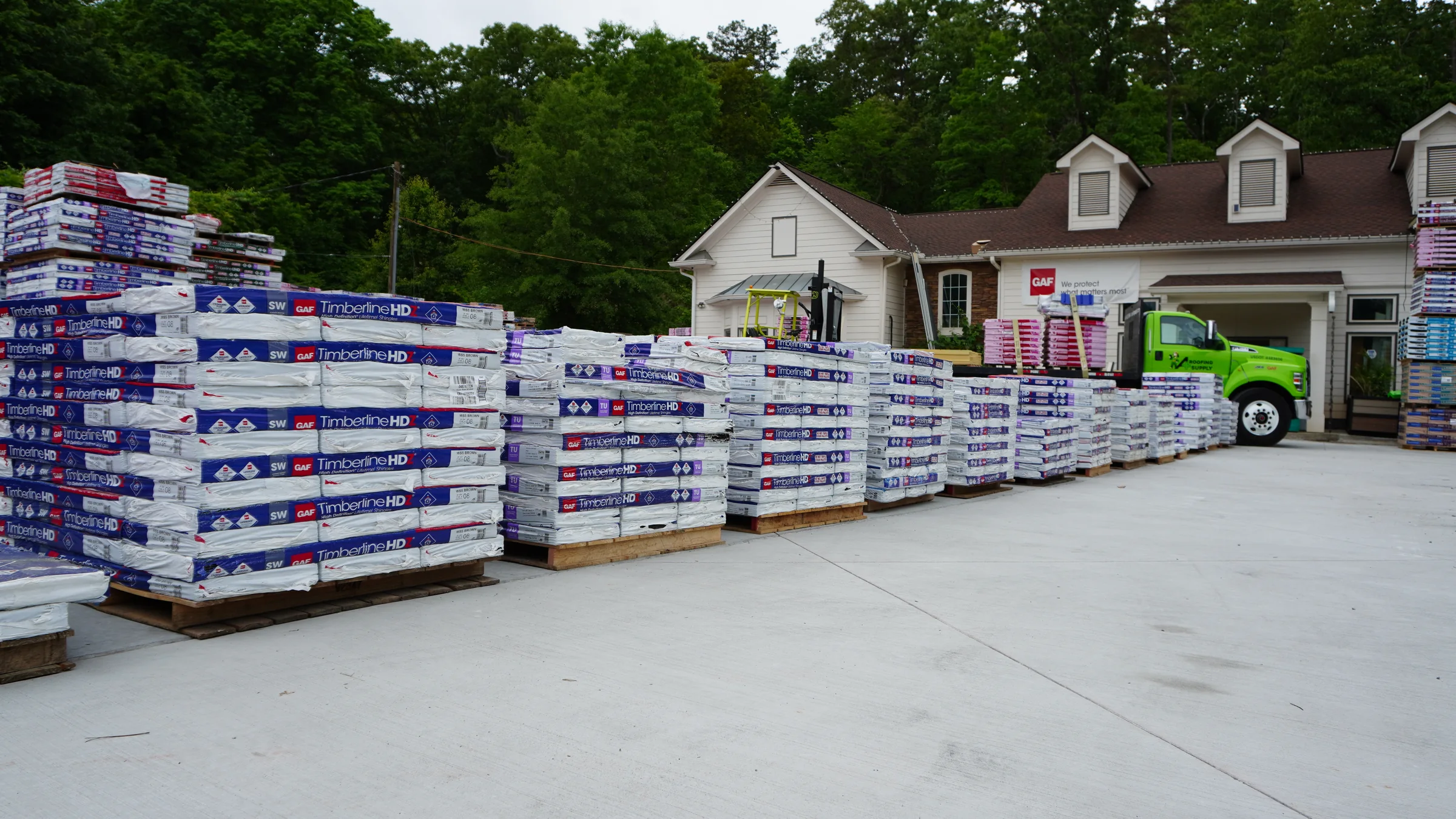 Roofing materials organized outside the A+ Roofing Supply warehouse