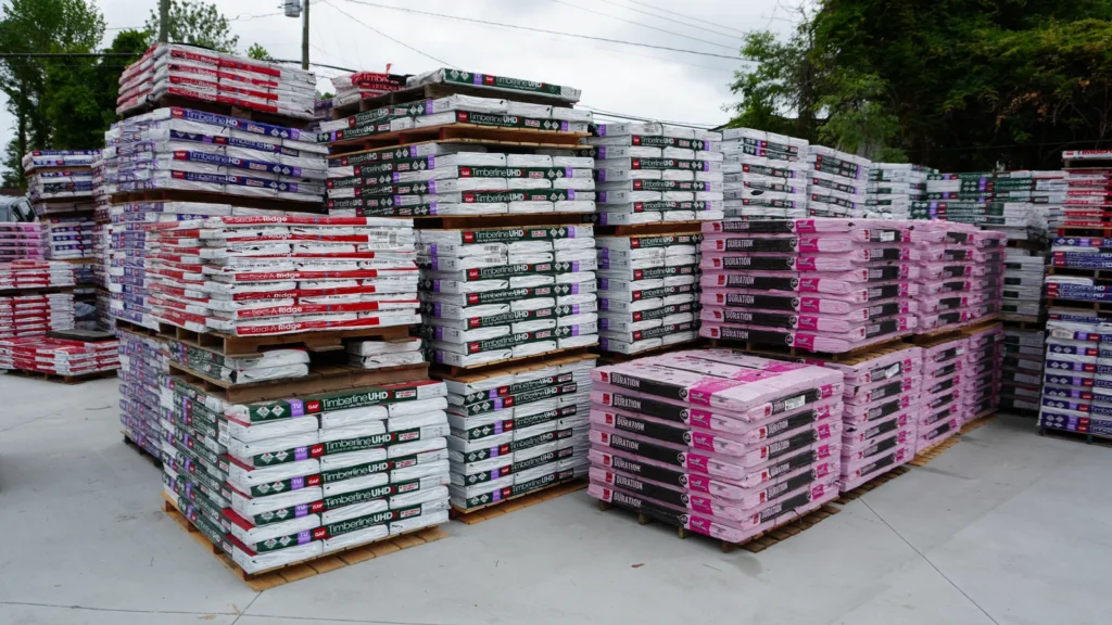 Pallets of GAF Timberline UHDZ, Seal-A-Ridge and Owens Corning Duration bundles.